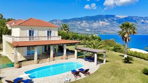 a villa with a swimming pool and views of the ocean at Villa Dimitra in Trapezaki