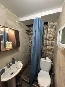 a bathroom with a toilet and a sink at Alpha apartment 43 in Serres +7 photos