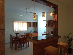 a kitchen and dining room with a table and chairs at Casa Branca Retreat &Hub in Varkala