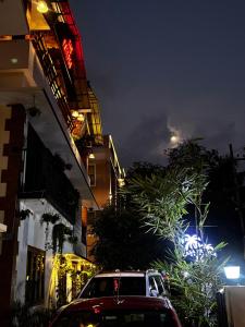 a car parked in front of a building at night at Casa Branca Retreat &Hub in Varkala