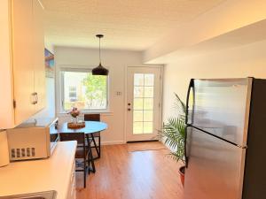 a kitchen with a refrigerator and a table at Entire Private Guest Suit - UC Berkeley, SF in El Cerrito