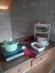 a counter top with a pot and utensils on it at Rooms DVORIŠTA in Žabljak