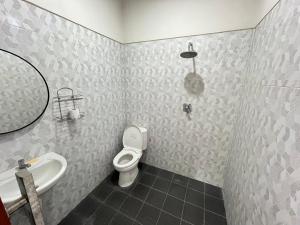 a bathroom with a toilet and a sink and a mirror at D Teba Ubud Villa in Ubud +10 photos