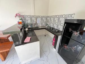 a kitchen with a counter and a counter top at D Teba Ubud Villa in Ubud