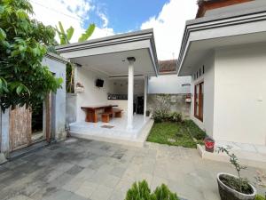 a patio with a wooden table in a house at D Teba Ubud Villa in Ubud