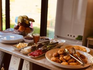 a table topped with plates and bowls of food at Gogo Moustache Guest House in Përmet