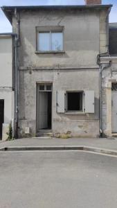 a building with an open door and two windows at Studio meublé centre ville- gare Villers Cotterets in Villers-Cotterêts +4 photos