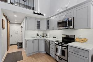 Una cocina con gabinetes blancos y un horno de estufa. en #LazyBear Tahoe Dreamy Escape, en Tahoe Vista