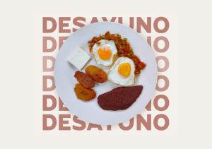 a plate of breakfast food with eggs and meat at El Patio de Don Moncho in Nueva San Salvador