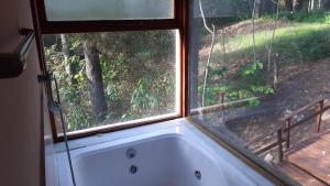 a bath tub in front of a window at Loft 35 metros cuadrados in Mar de las Pampas +6 photos