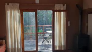an open door to a deck with a view of a patio at Loft 35 metros cuadrados in Mar de las Pampas