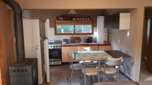 a kitchen with a table and chairs and a stove at Loft 35 metros cuadrados in Mar de las Pampas