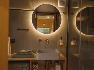 a bathroom with a sink and a mirror at Luxe nature escape - outdoor bath - Byronshire in Mullumbimby