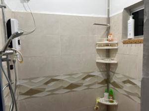 a bathroom with a shower with a tiled floor at Opening promo Taman Seri Lalang Kluang in Kluang +6 photos