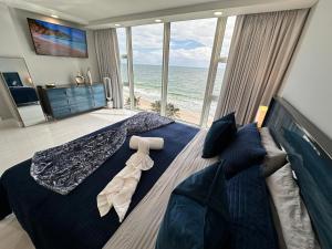 a bedroom with a large bed with a view of the ocean at Ocean Front on Fort Lauderdale Beach 2 br Condo Apartment in Fort Lauderdale +24 photos