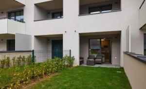 a white house with a lawn in front of it at Alfa Albelli Free Parking Air Condition in Košice +36 photos