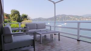 a balcony with chairs and a table and a view of the water at Ranco Villa - 14006 in Ranco