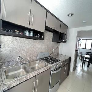 a kitchen with a sink and a stove at Casa en Tehuacán Se puede facturar in Cedro