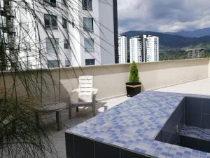 a balcony with a table and chairs on a building at Beautiful apartment with rooftop in Armenia