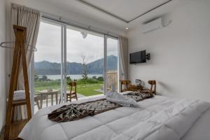 a bedroom with two beds and a large window at Pandawa Glamping Kintamani in Bangli +68 photos