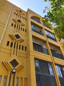 a yellow building with balconies on the side of it at PH1 Plaza 3 Rodadero in Santa Marta