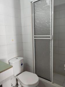 a bathroom with a toilet and a glass shower at PH1 Plaza 3 Rodadero in Santa Marta
