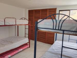 a room with two bunk beds and a window at PH1 Plaza 3 Rodadero in Santa Marta