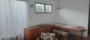 a room with a wooden table and chairs and a window at Casa Lafken in Mirasol