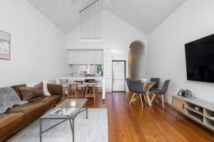 a living room with a couch and a table at Portside by Property Mums in Melbourne