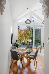 a dining room with a table and chairs at Portside by Property Mums in Melbourne