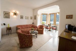 ein Wohnzimmer mit einem Sofa und einem Tisch in der Unterkunft Lake Lugano Apartment - 14538 in Valsolda