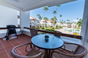 a table and chairs on a balcony with a view of the beach at STANZA MARE 1 Br,2Br,3Br APARTAMENT ON THE BEACH in Punta Cana