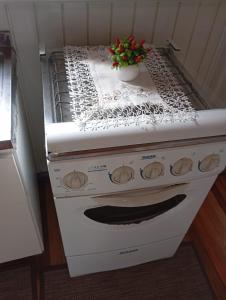 a stove with a plant sitting on top of it at Pousada 4 Estações in Louro Müller +17 photos