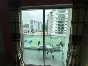 a room with a balcony with a view of a pool at Family Stay at Quintet A3A-3A-6 in Tanah Rata