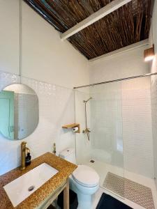 a bathroom with a toilet and a sink and a shower at Chành Rành House in Vĩnh Hy