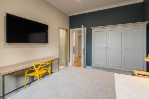 Camera con scrivania e sedia gialla. di 3BR Gem West End Walk to Glasgow Uni Parking a Glasgow