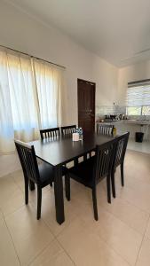 a dining room table and chairs in a room at MP Homestay Kota Marudu in Gua Sai +3 photos