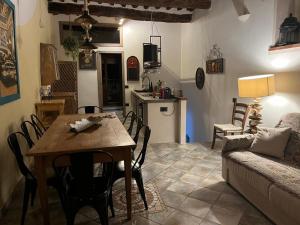 a kitchen and living room with a table and a couch at Under The Tuscan Sun in Monterotondo