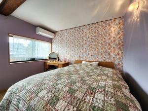 Postel nebo postele na pokoji v ubytování タイピーハウス
