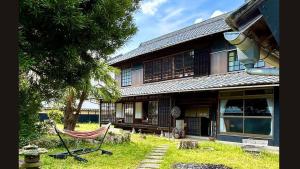 a house with a hammock in front of it at nano inn in Kanagawa