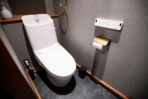 a bathroom with a white toilet in a stall at Relam Glamping Resort Gotemba in Gotemba +17 photos