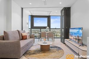 a living room with a couch and a table at QW Luxury River City Views in Brisbane