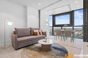 a living room with a couch and a table at QW Luxury River City Views in Brisbane