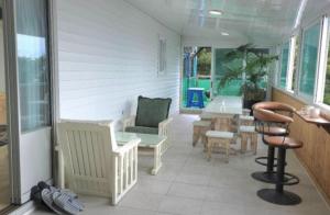 a living room with a table and chairs and a room with a table at Ganghwado Katana Pension in Incheon +3 photos