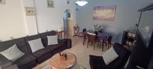 a living room with a couch and chairs and a table at La perle de Kouba lacroix in Alger