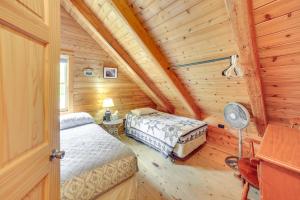 a bedroom with two beds in a log cabin at UP Badger Lodge BnB-Loft Family in Wetmore
