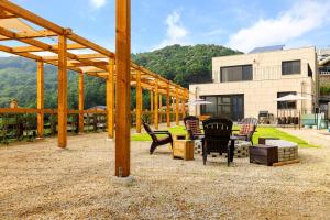 un gruppo di sedie seduti di fronte a un edificio di Gapyeong V Courtyard Pension a Gapyeong