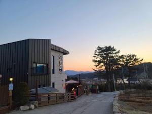 a building with a clock on the side of it at Gyeongju Art Hill Family Group Pet-Friendly Pension in Gyeongju