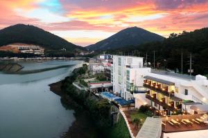 an aerial view of a city with a river and mountains at Yeosu Pension Daom Pet Pension in Kulchŏn