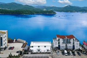 a view of a large body of water with buildings at Yeosu Pension Daom Pet Pension in Kulchŏn